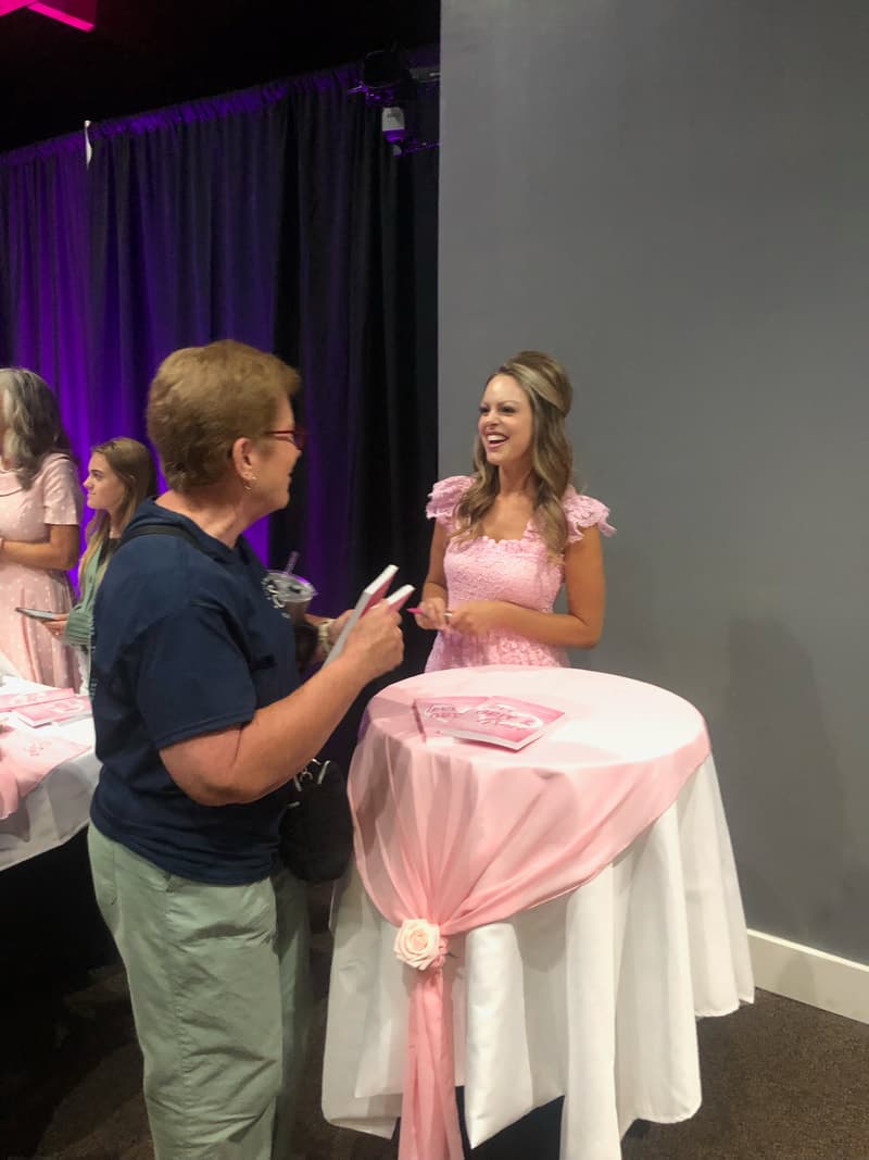 Amanda speaking with a reader at a book event